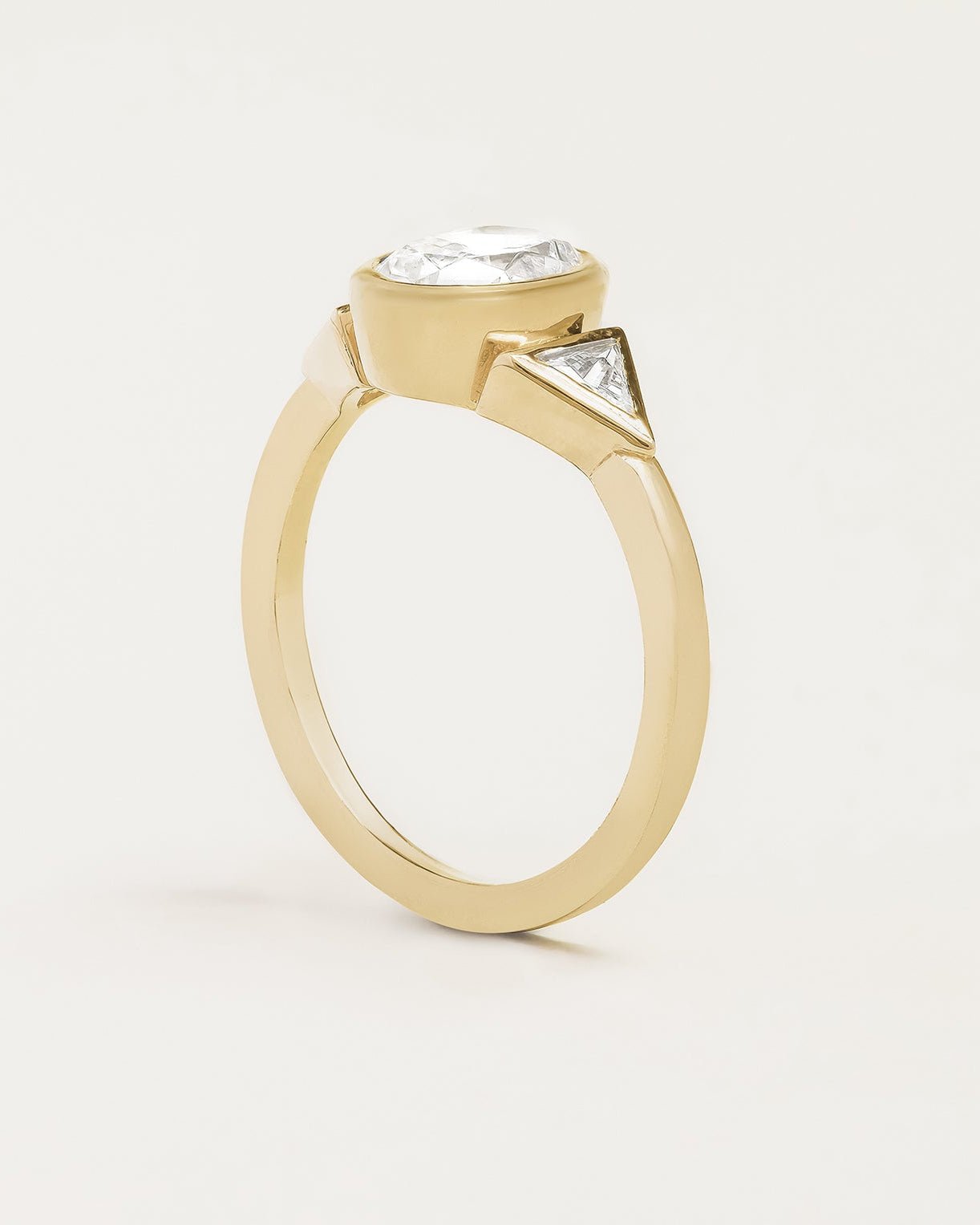 Oval & Trillion Cut Diamond Three Stone Bezel Ring