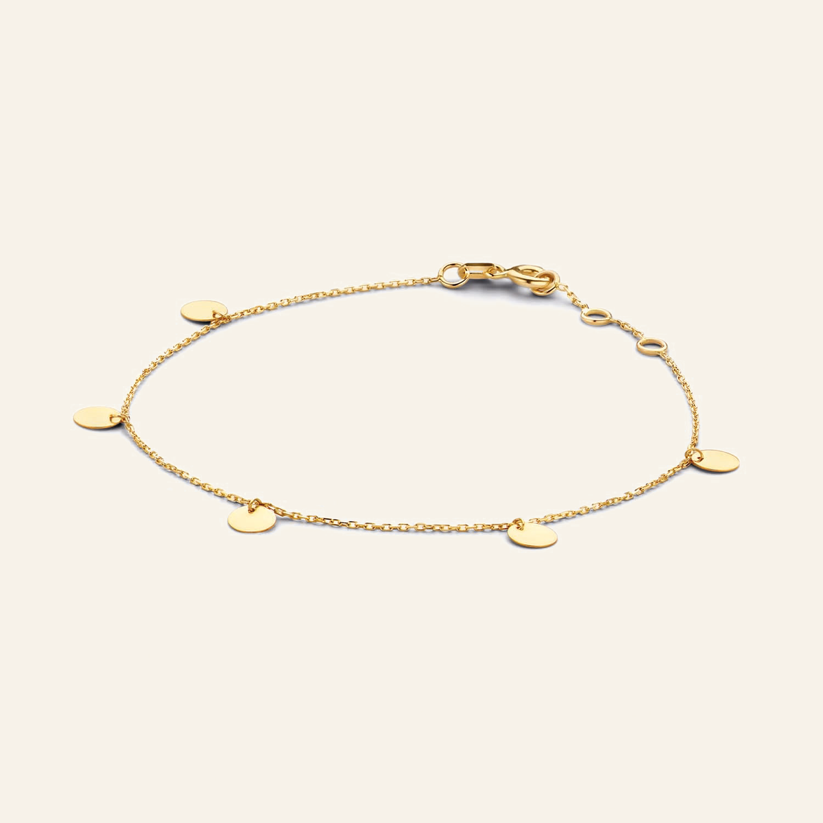 Jackie Amsterdam Discs bracelet in 14K yellow gold on light beige background