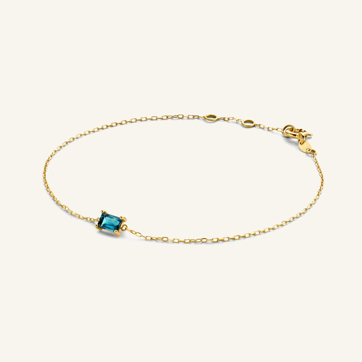 Jackie Amsterdam Medina Topaz bracelet in 14K yellow gold on pale beige background