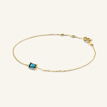Jackie Amsterdam Medina Topaz bracelet in 14K yellow gold on pale beige background