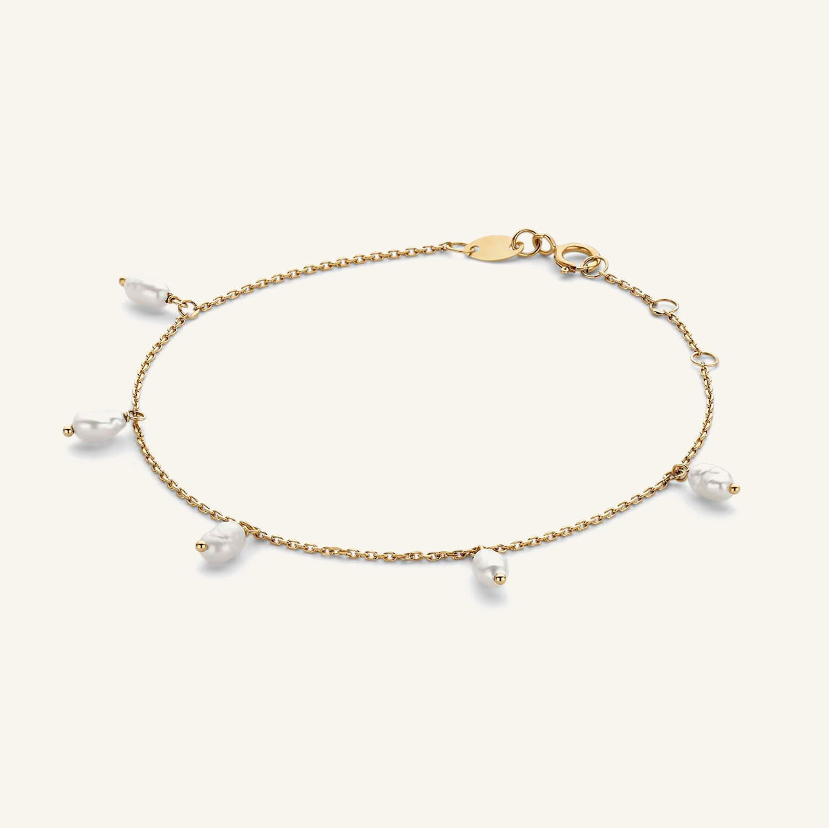Jackie Amsterdam Pearl of Amalfi bracelet in 14K yellow gold on pale beige background