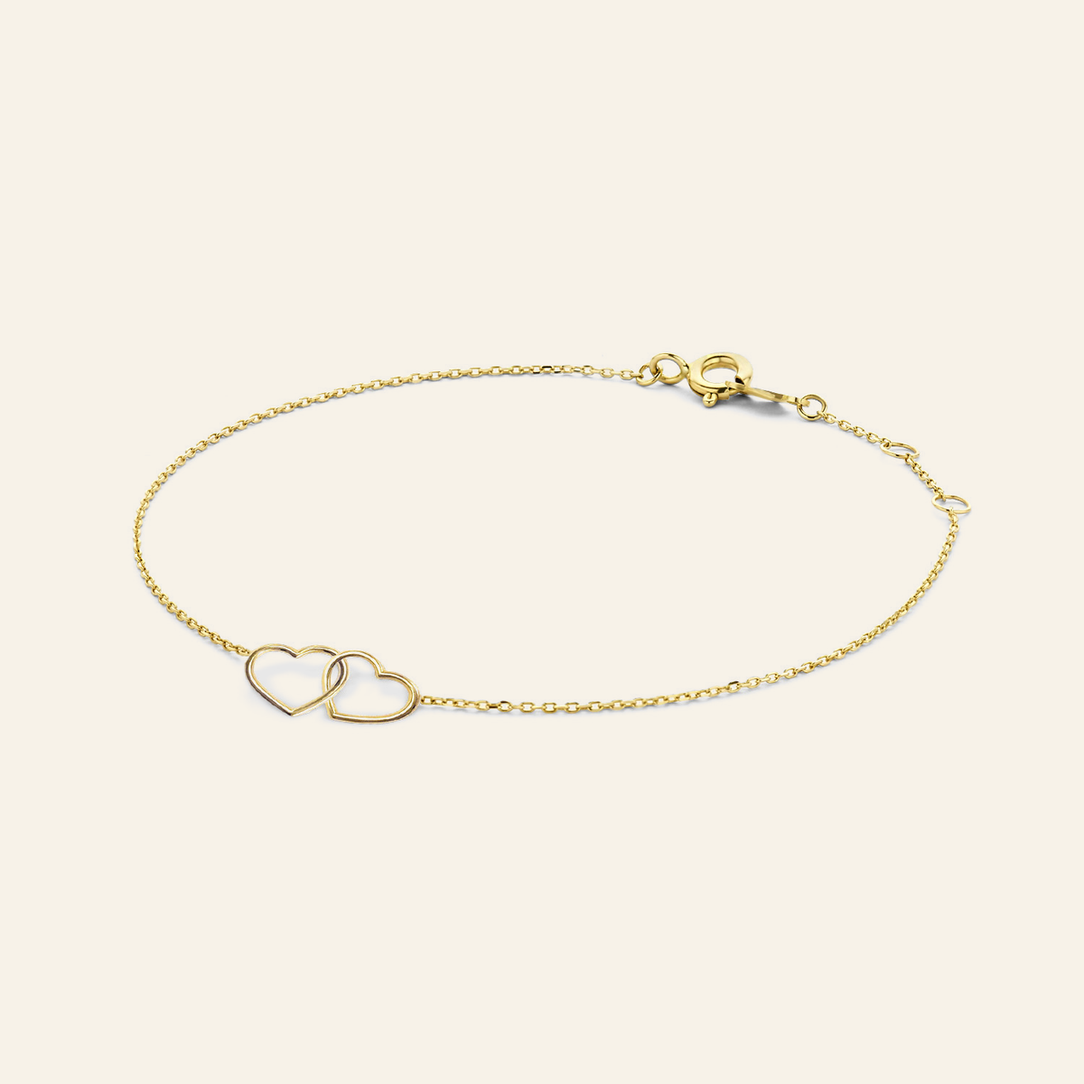 Jackie Amsterdam Double Heart Bracelet in 14K Yellow Gold on light beige background