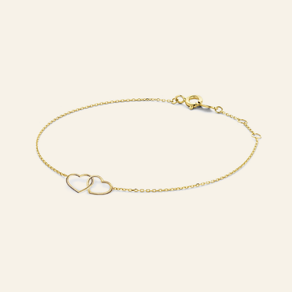 Jackie Amsterdam Double Heart Bracelet in 14K Yellow Gold on light beige background