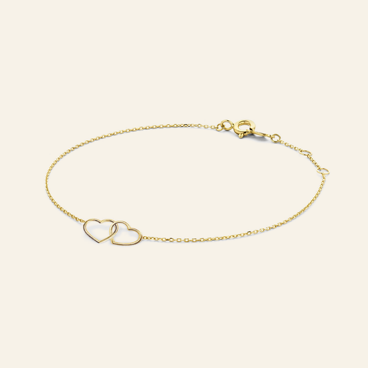Jackie Amsterdam Double Heart Bracelet in 14K Yellow Gold on light beige background