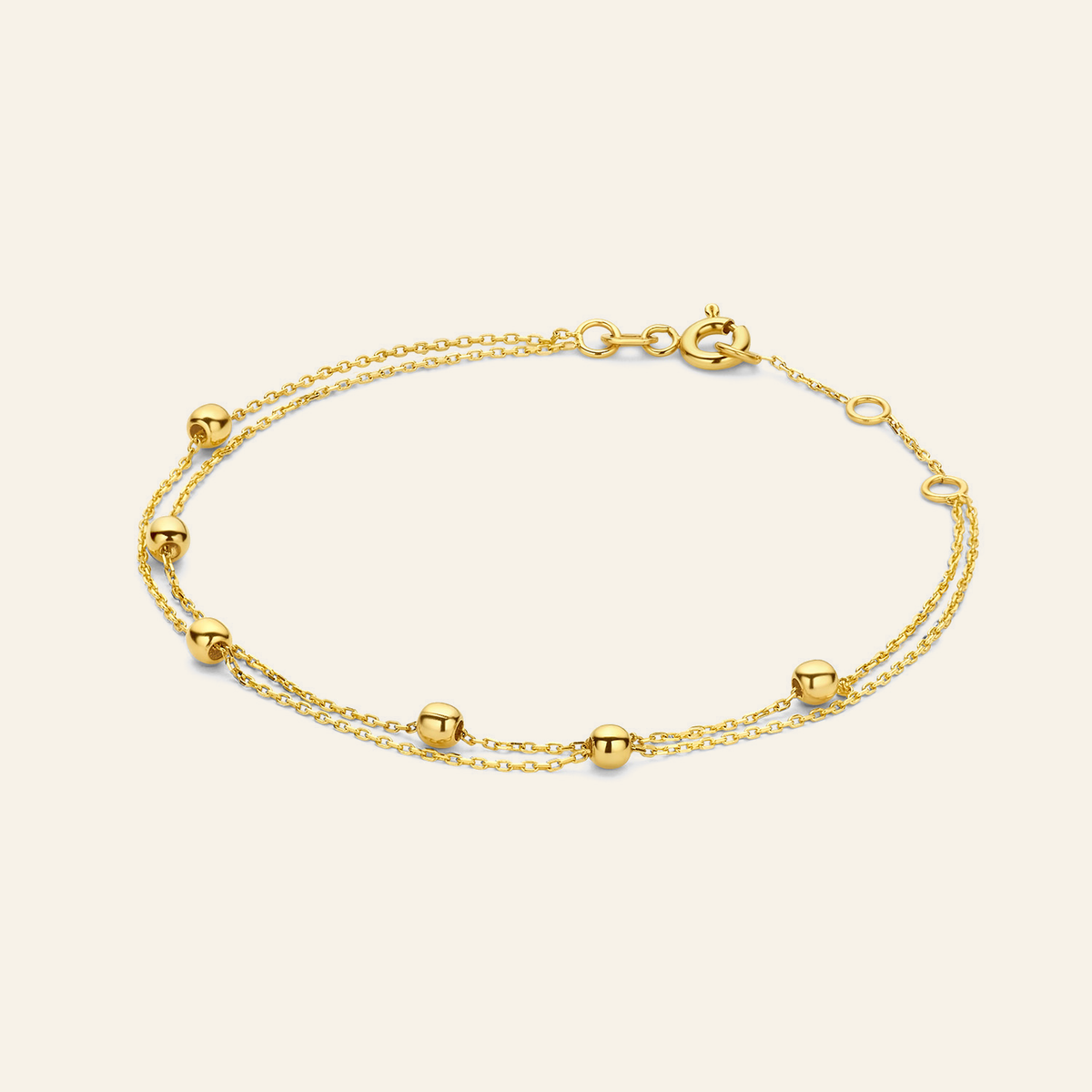 Jackie Amsterdam Double Bubble Bracelet in 14K Yellow Gold on light beige background