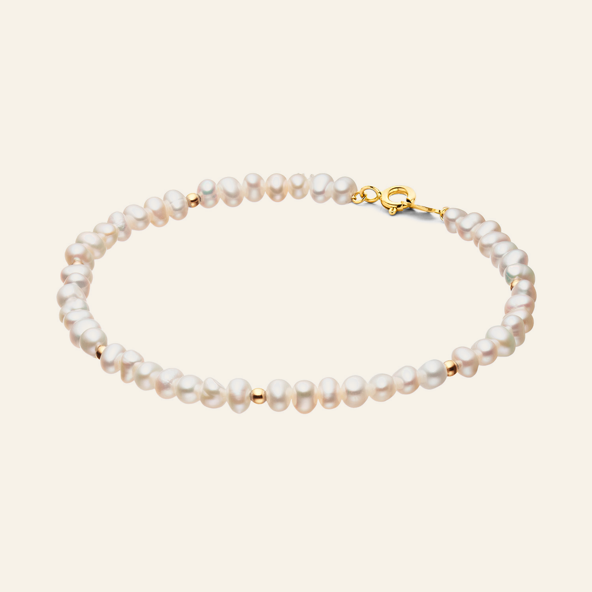 Jackie Amsterdam Pearl Potion Bracelet in 14K Yellow Gold on light beige background