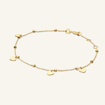 Jackie Amsterdam Corazon bracelet in 14K yellow gold on pale beige background