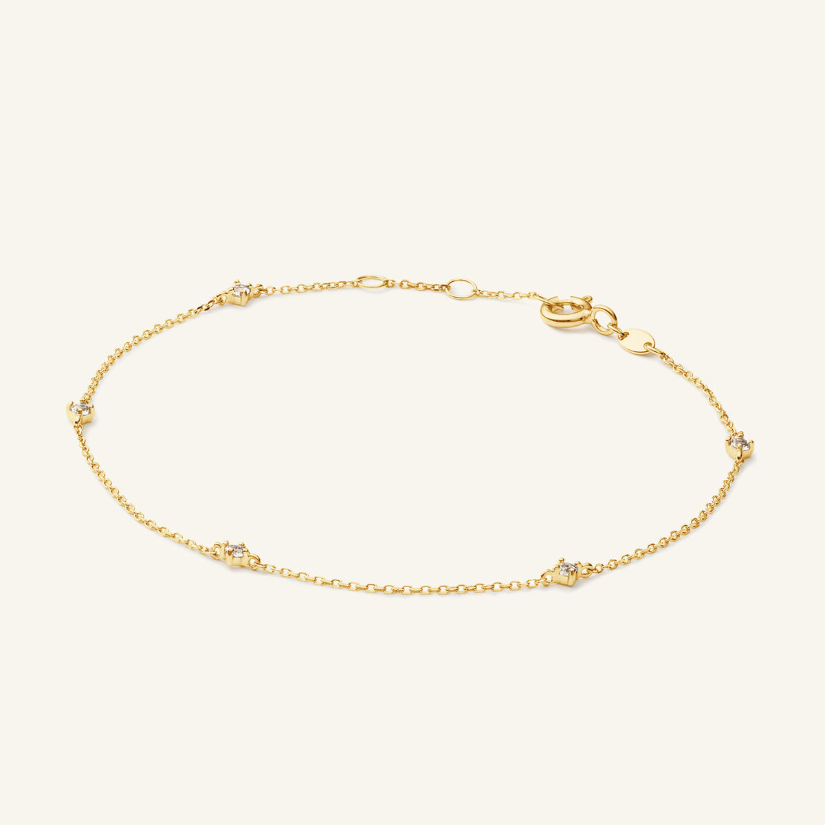 JKB25.585 Jackie White Topaz bracelet in 14K yellow gold on light beige background