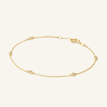 JKB25.585 Jackie White Topaz bracelet in 14K yellow gold on light beige background