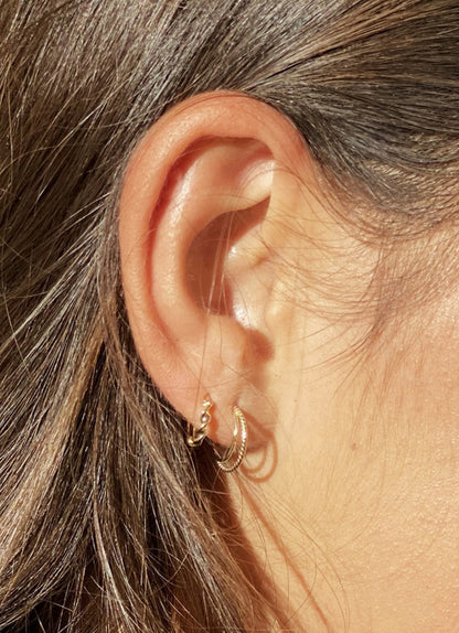 Jackie Twisted Double Hoop Earrings 11mm in 14K Yellow Gold worn on ear