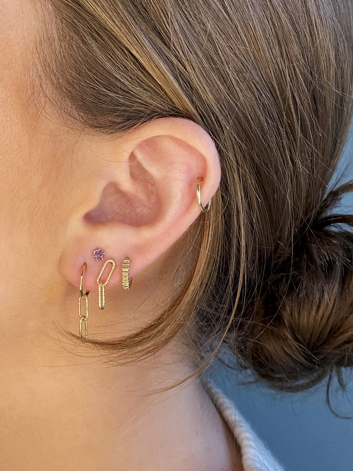 Jackie Mini Plain Hoops in 14K Yellow Gold worn on ear