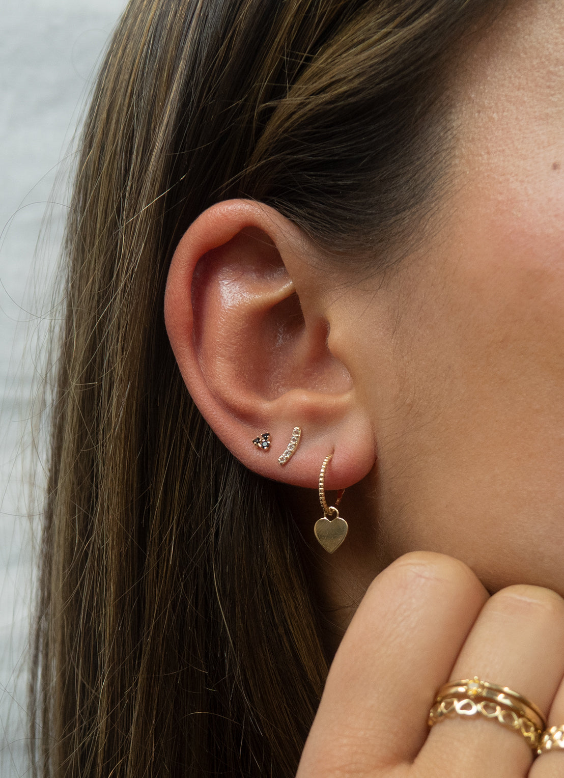 Jackie Miro Triangle Onyx Studs in 14K Yellow Gold worn on ear