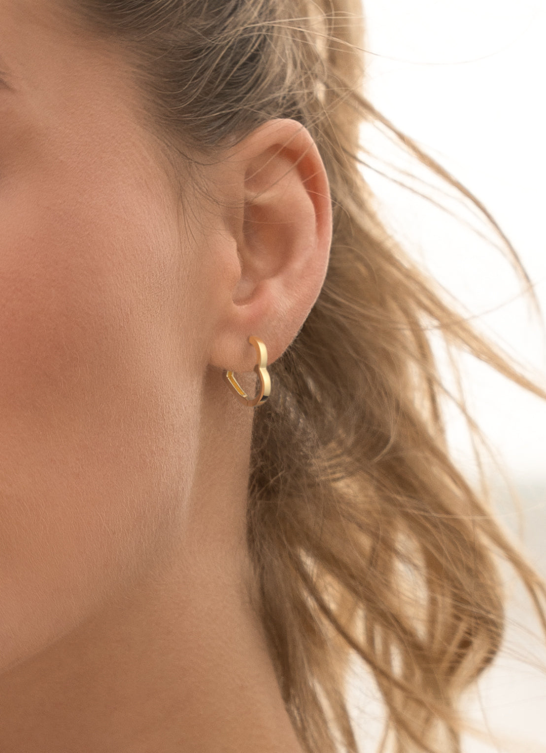 Jackie Hugging Hearts Hoops in 14K Yellow Gold worn on ear