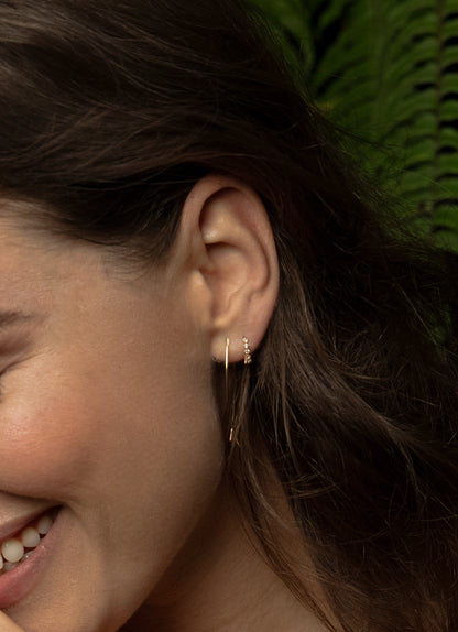 Jackie Radiance White Topaz Hoops in 14K Yellow Gold worn on ear