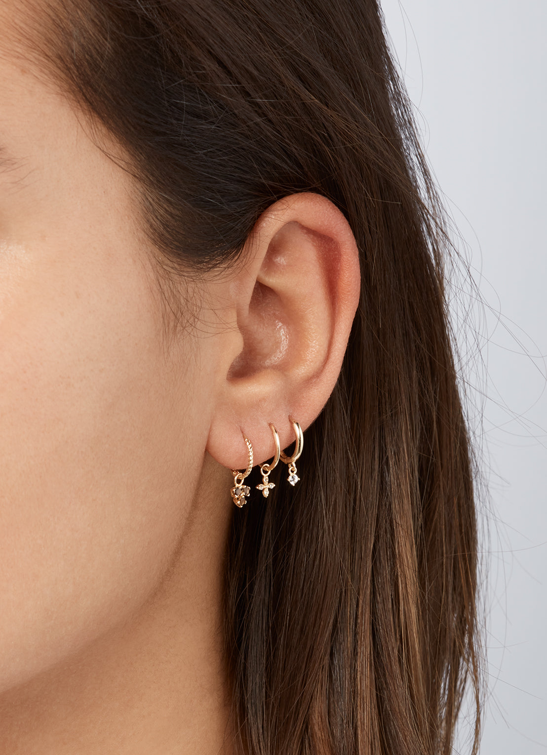Jackie Shining Star Hoops in 14K Yellow Gold worn on ear
