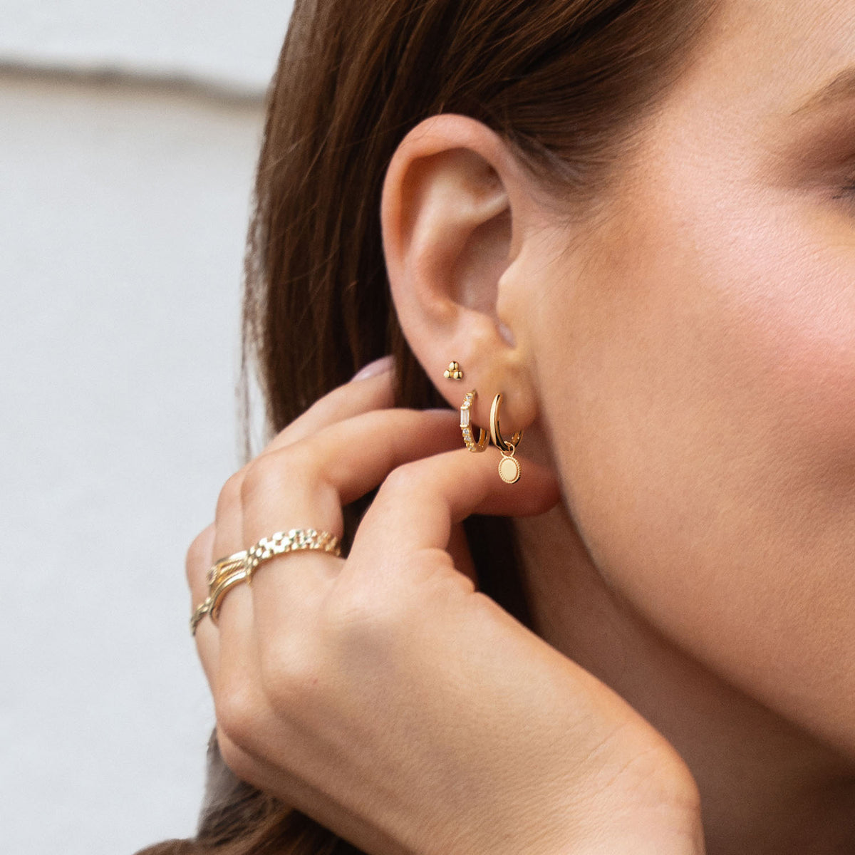 Jackie Old Mill Studs in 14K Yellow Gold worn on ear