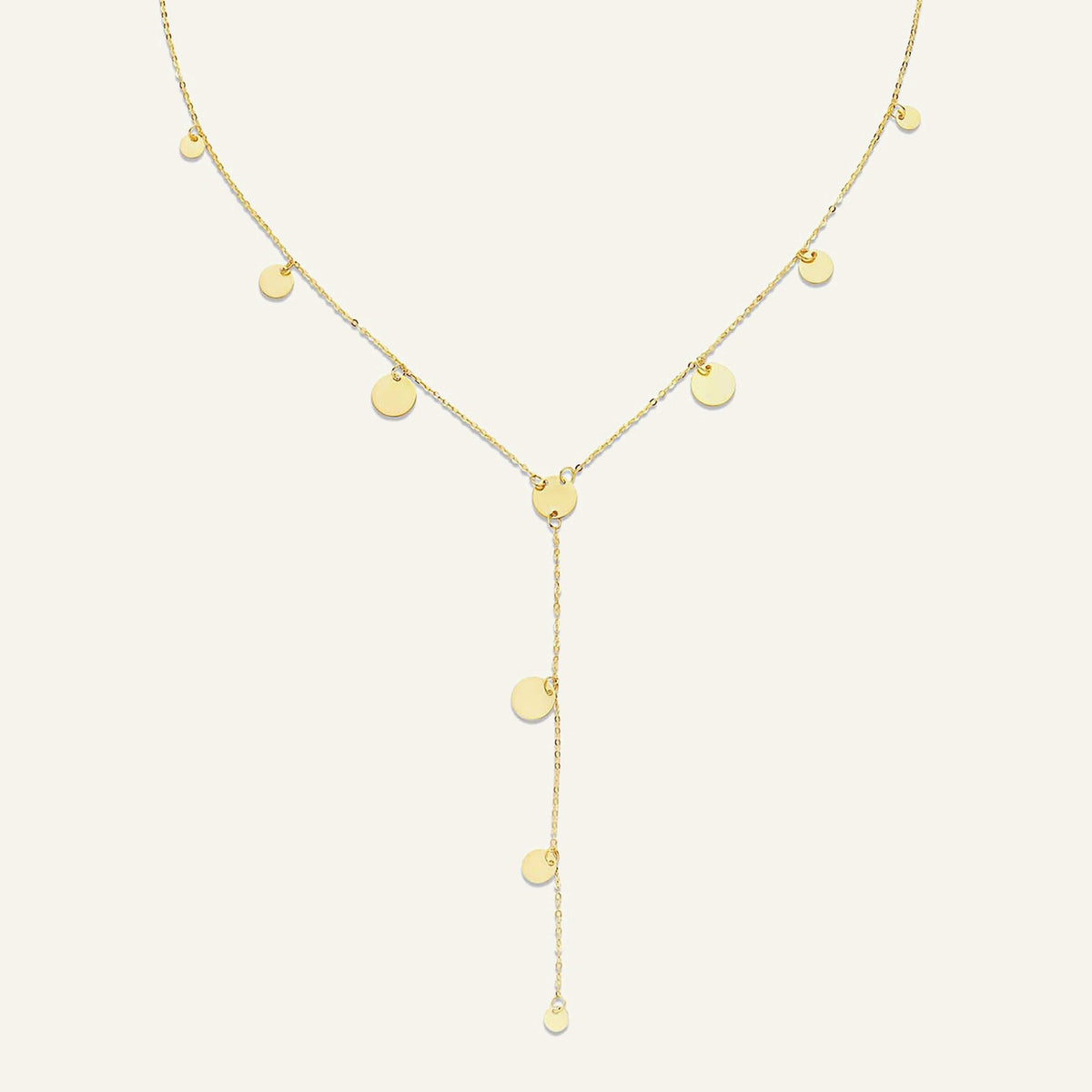 Jackie Amsterdam Dazzle Y-Necklace in 14K yellow gold on pale beige background