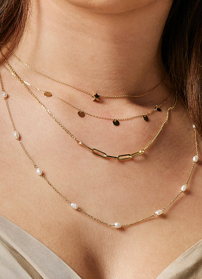 Jackie Amsterdam Disc necklace worn layered on model