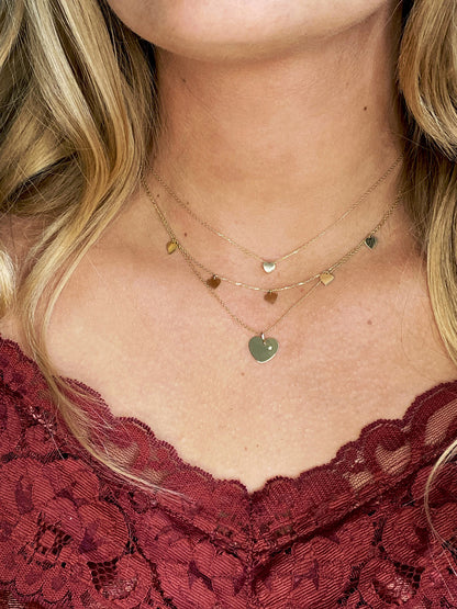 Jackie Amsterdam Plain Heart necklace worn layered on model