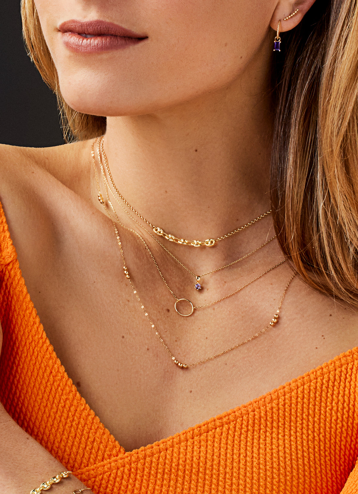 Jackie Amsterdam Circle Silhouette necklace worn layered on model