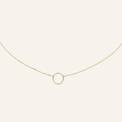 Jackie Amsterdam Circle Silhouette necklace in 14K yellow gold on pale beige background