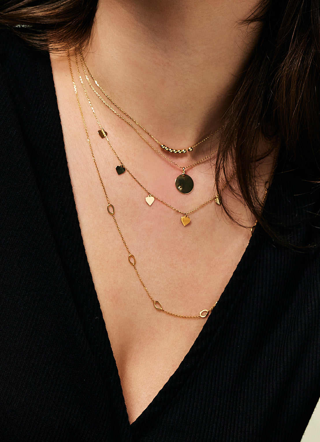 Jackie Amsterdam Mini Dots necklace worn layered on model