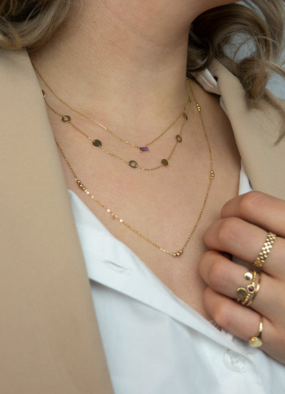 Jackie Amsterdam Medina Amethyst necklace worn layered on model