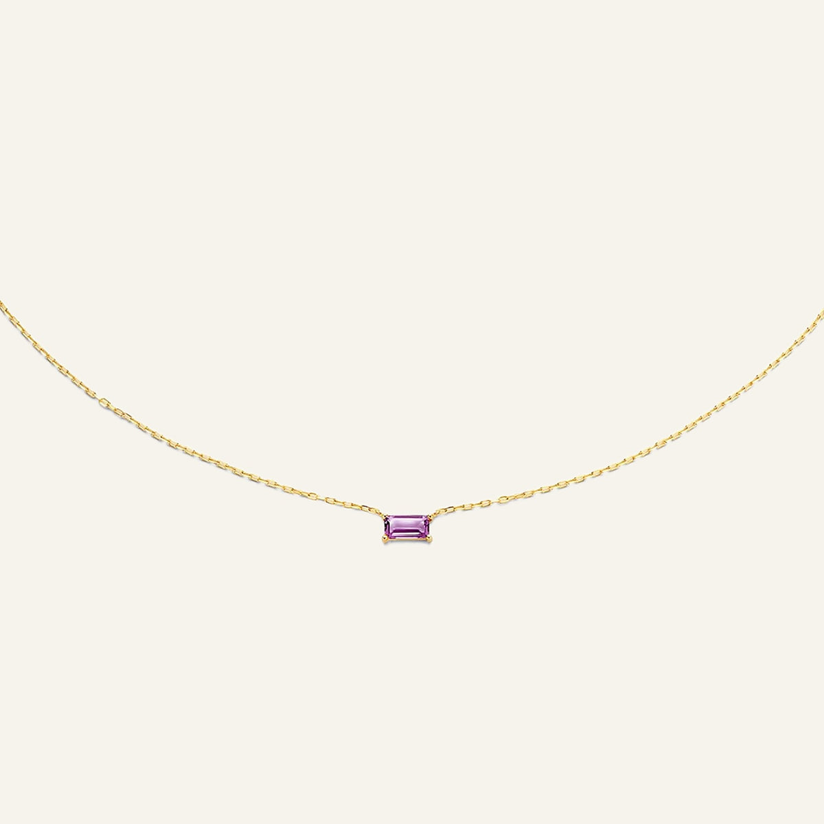 Jackie Amsterdam Medina Amethyst necklace in 14K yellow gold on pale beige background