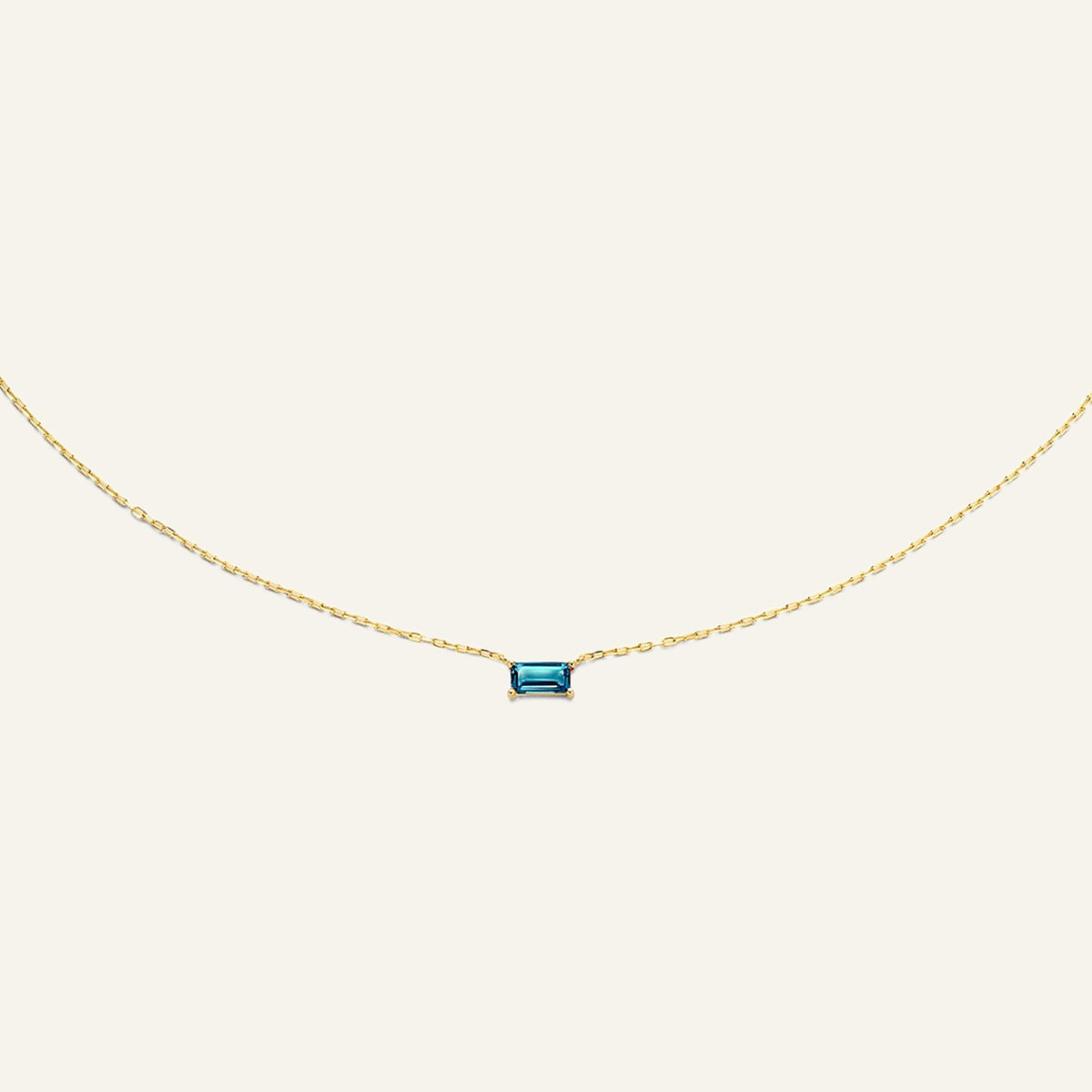 Jackie Amsterdam Medina Topaz necklace in 14K yellow gold on pale beige background
