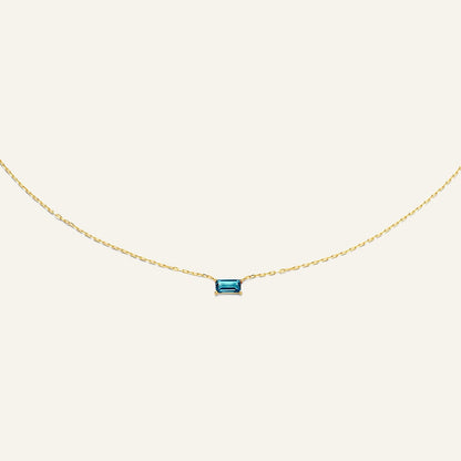 Jackie Amsterdam Medina Topaz necklace in 14K yellow gold on pale beige background