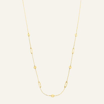 Jackie Amsterdam Beaux Arts necklace in 14K yellow gold on pale beige background