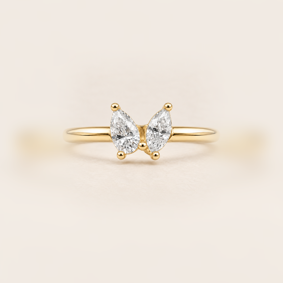 Double Pear Diamond Ring in Gold product photo on warm beige background