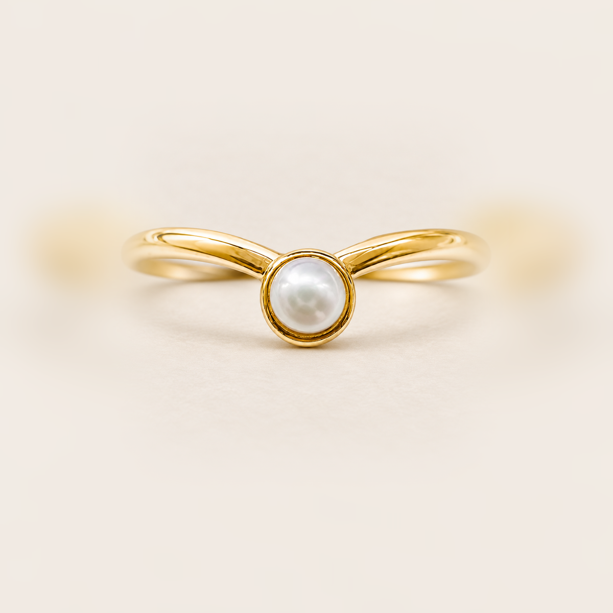 Pearl Bezel Ring in Gold product photo on warm beige background