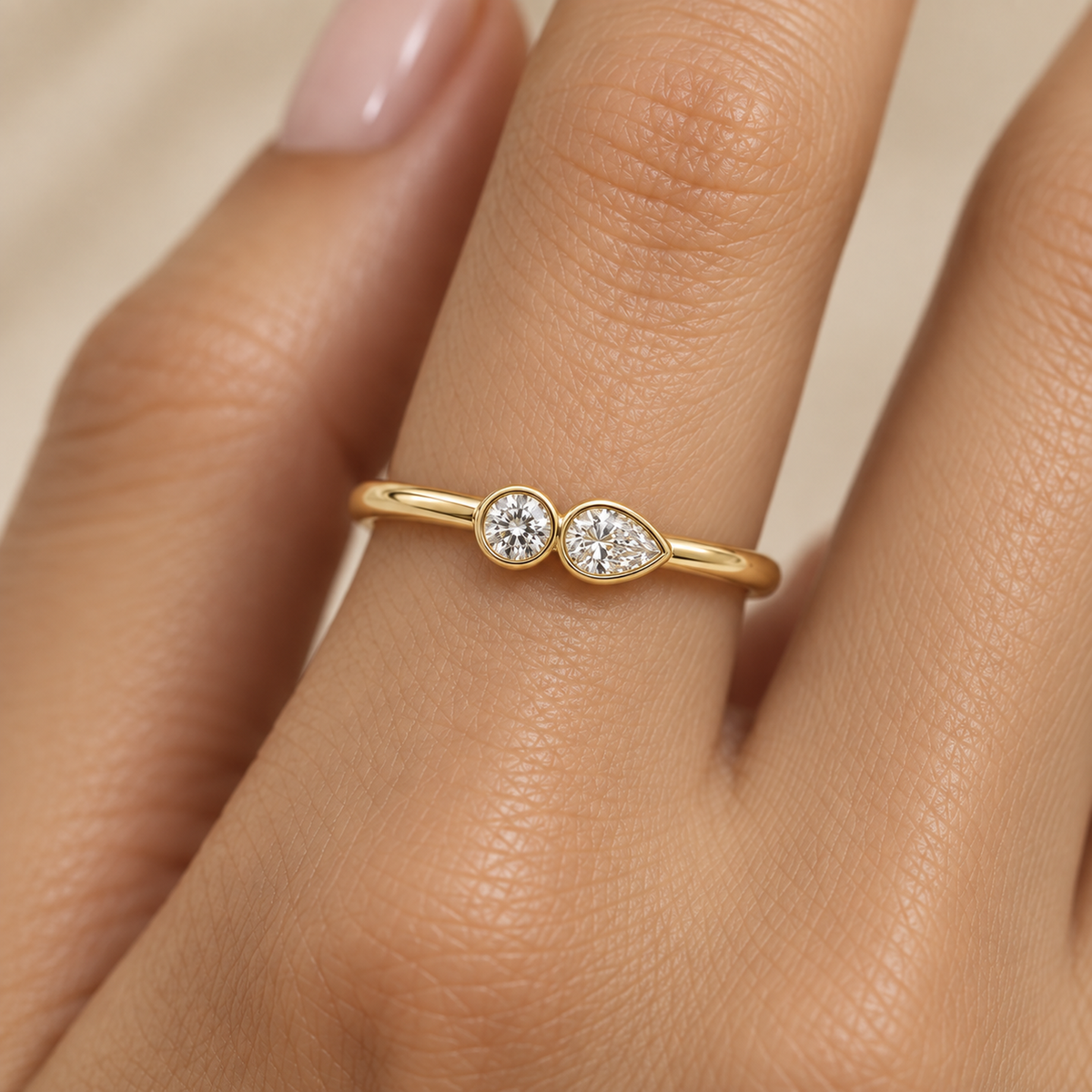 Round and Pear Bezel Diamond Ring in Gold illustrative worn view with indicative color and proportions