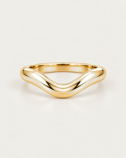 Curved 3mm gold wedding band on warm neutral background