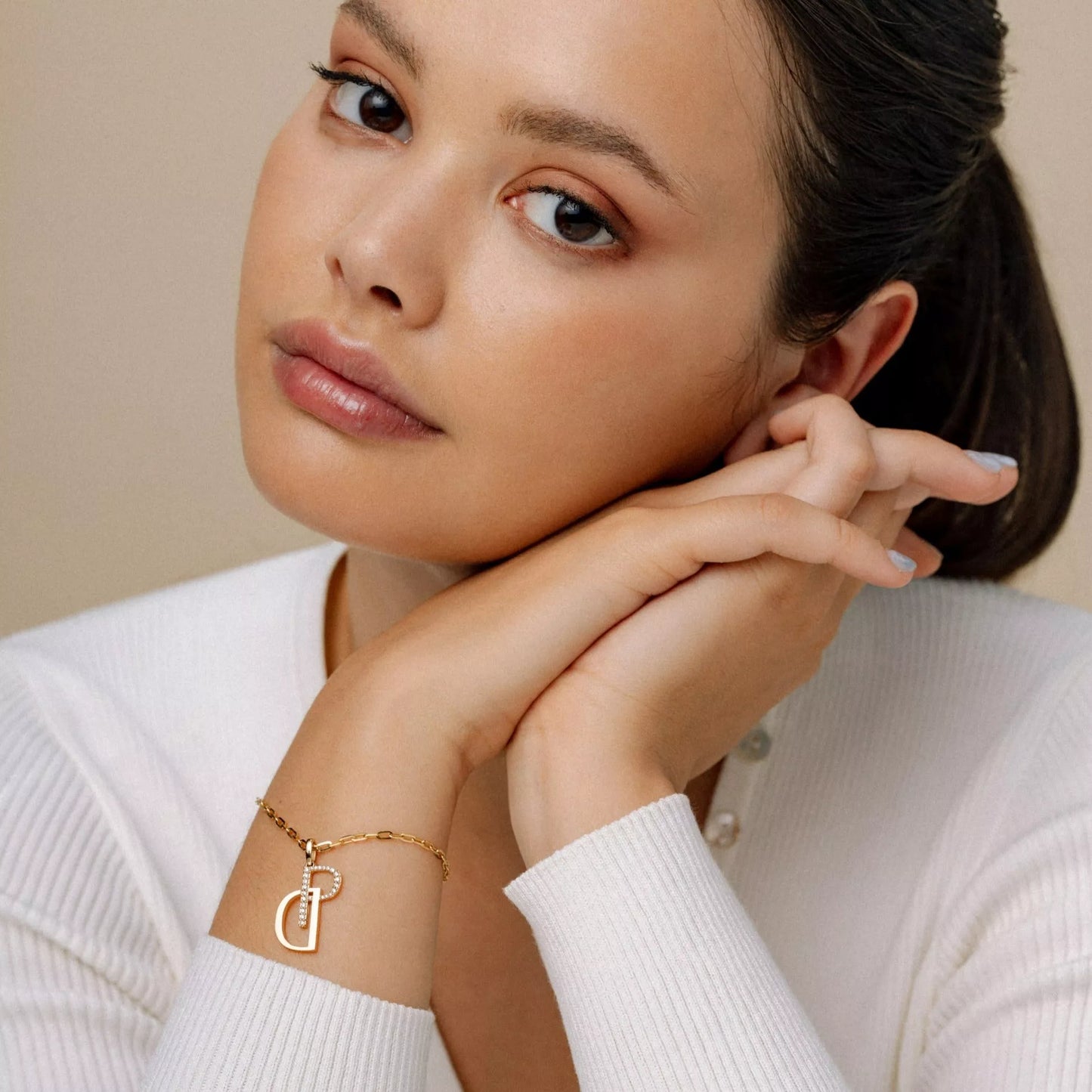 The Signature Charm Bracelet on Model. 14K Recycle Solid Gold.